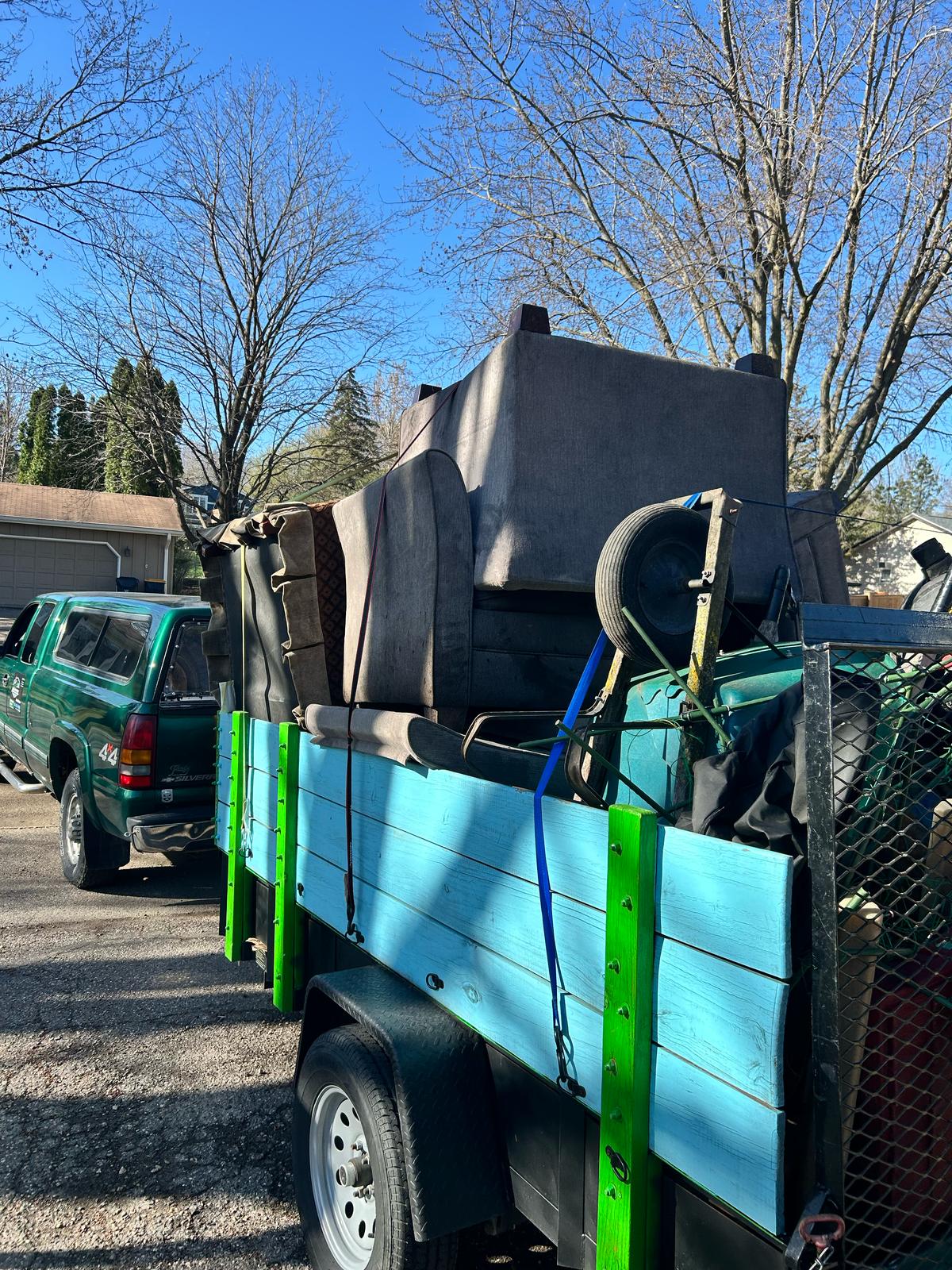 Loading items onto the El Flee's Junk Removal truck